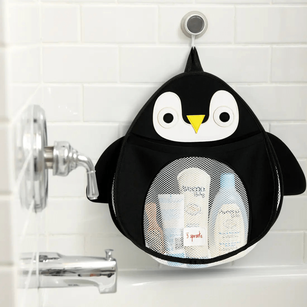 3 Sprouts Bath Storage bag in penguin design, hanging on a bathroom tile with mesh pockets holding toiletries.