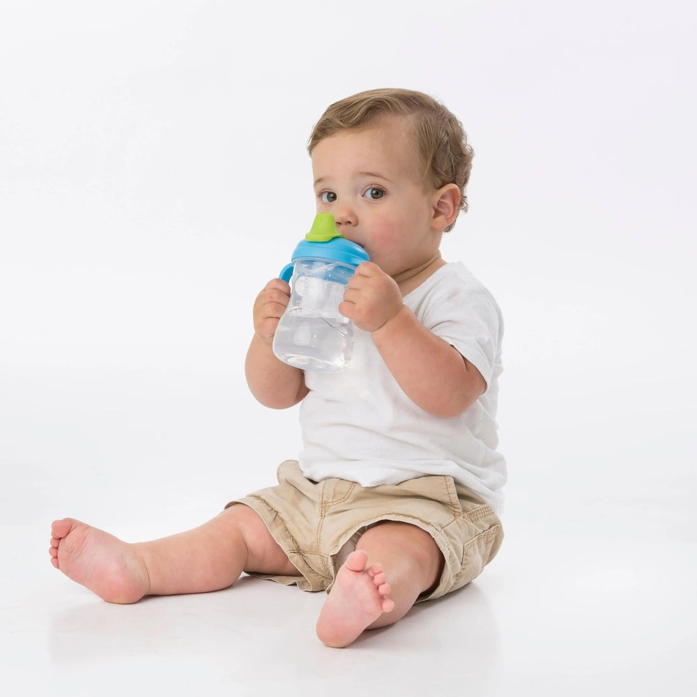 B.Box Spout Cup for toddlers with blue lid and green spout, being held by a baby.