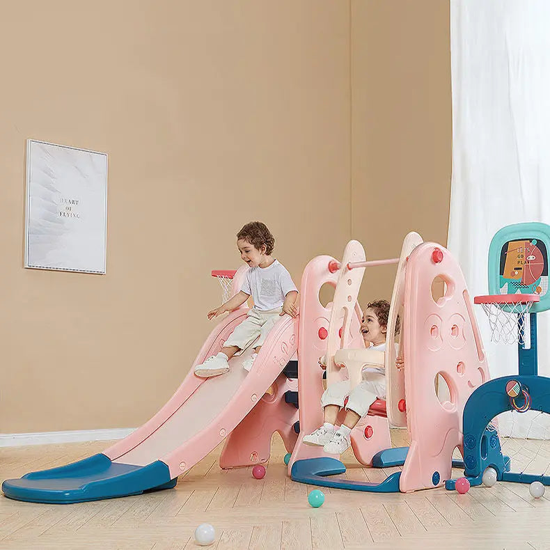 BC Babycare 5-In-1 Slide playset in pink and blue; kids slide indoors, showing active play on sturdy plastic steps.