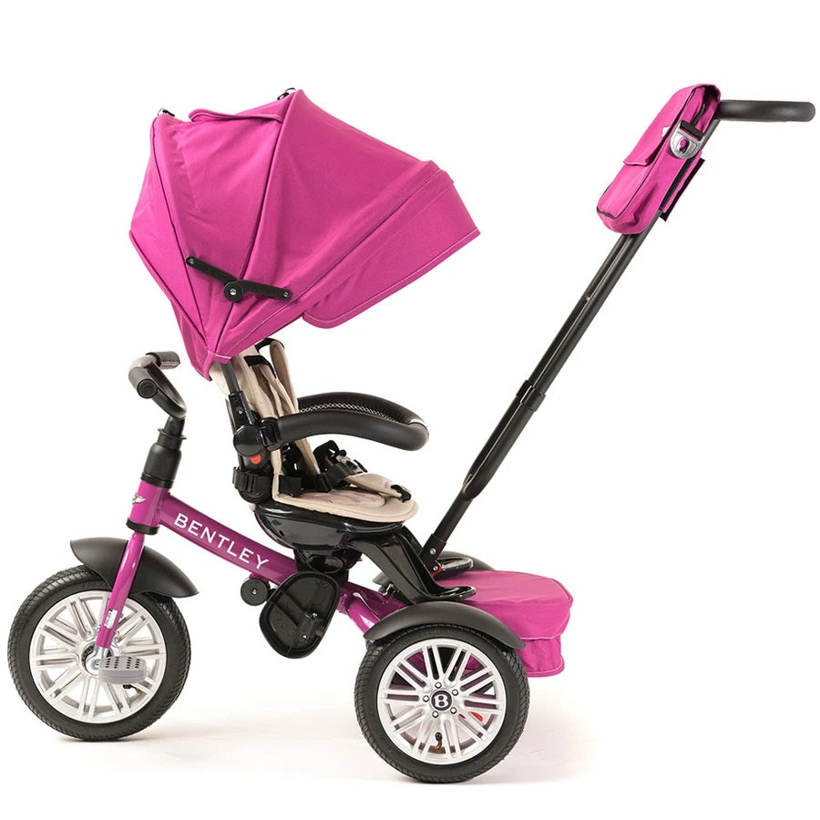 Bentley Trike 6-In-1 V2 Fuchsia Pink with beige seat and canopy; extended push handle shows easy steering.
