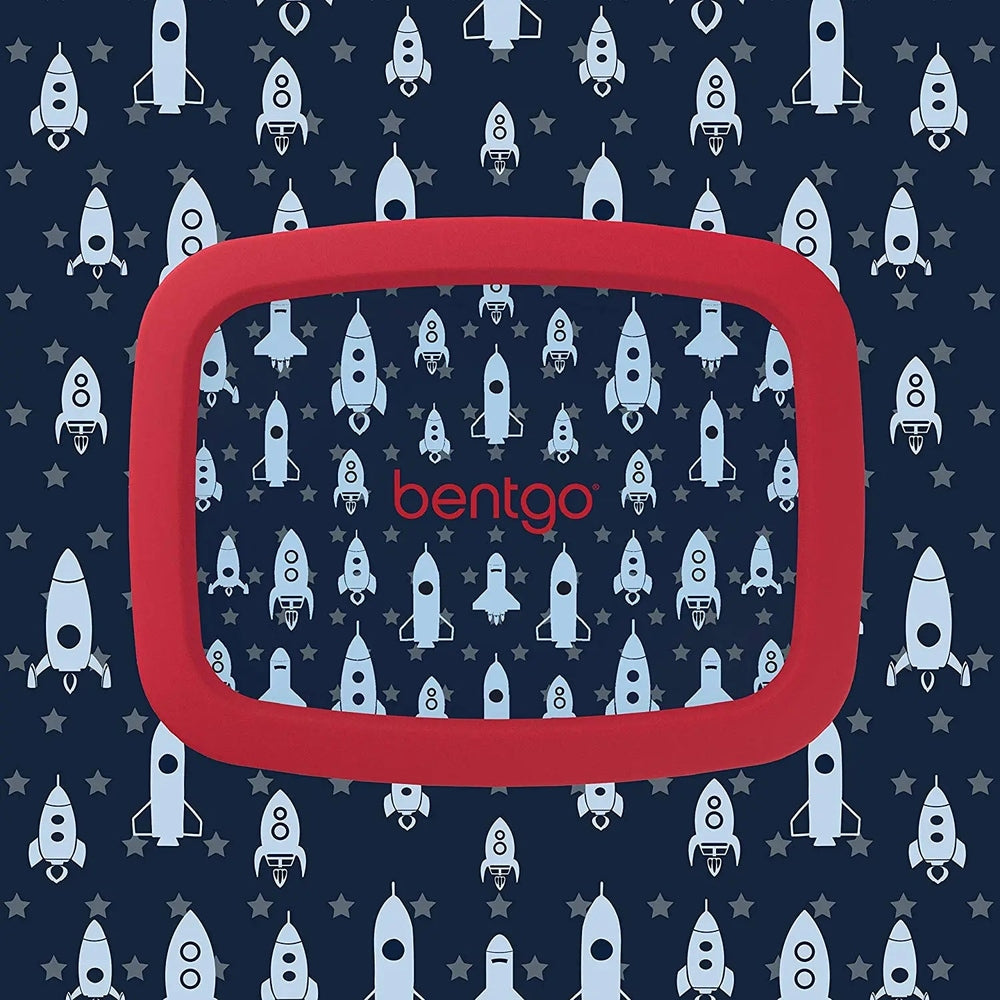 Bentogo Kids Prints Bento Lunch Box with a red rounded frame shown against a navy rocket pattern.