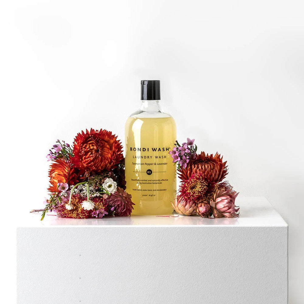 Bondi Wash laundry wash 500 ml bottle with Tasmanian Pepper & Lavender surrounded by red and pink dried flowers