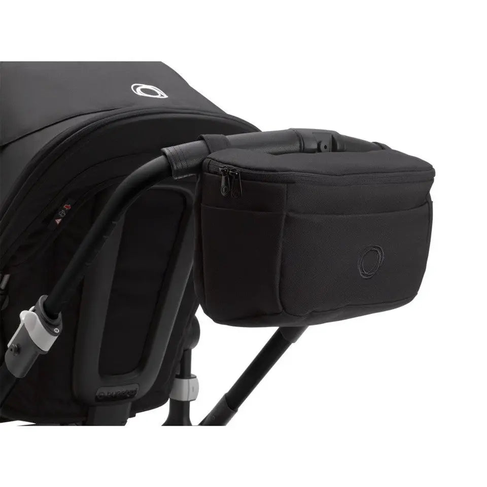 Bugaboo Organizer stroller bag in black clipped to the handlebar for quick on-the-go storage.