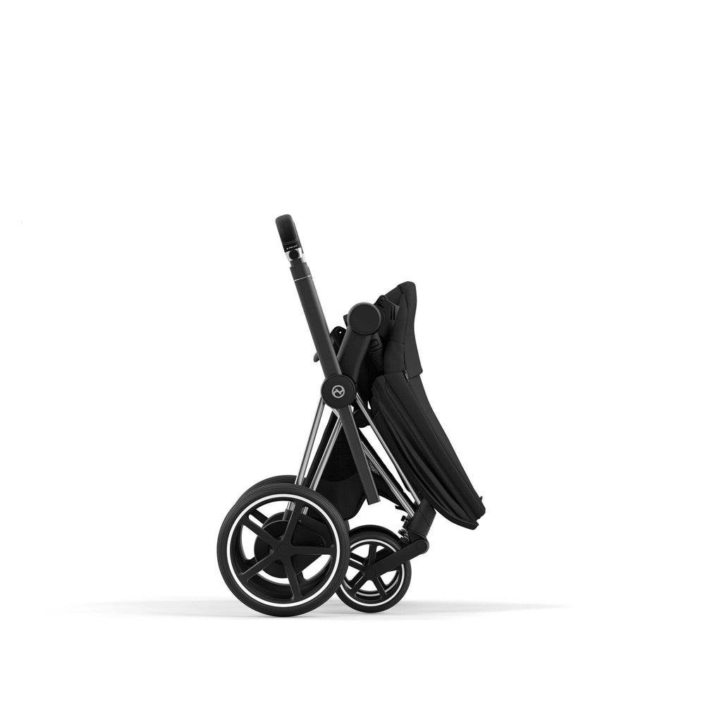 CYBEX e-Priam Chrome Frame stroller in Deep Black, folded with compact stance and visible dual wheels.