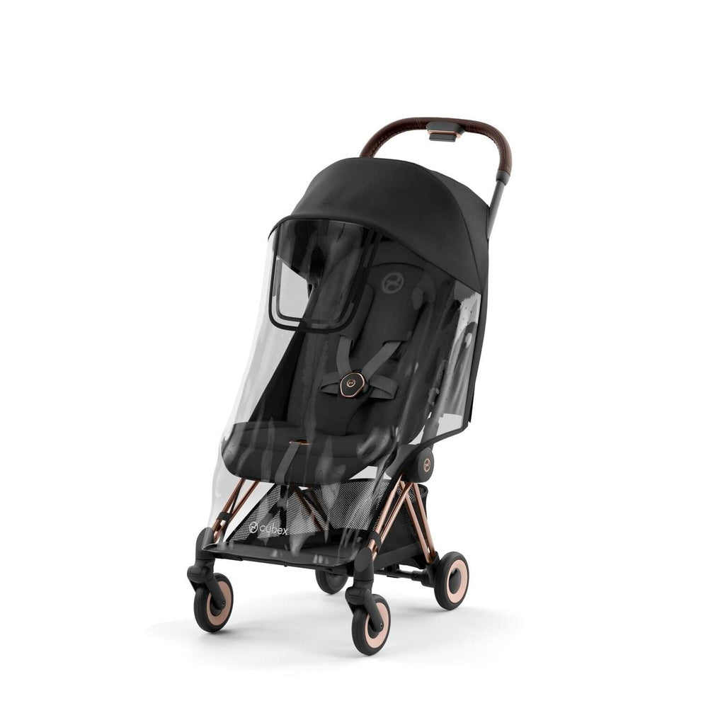 Cybex Coya rain cover for stroller with clear canopy on black stroller and bronze accents