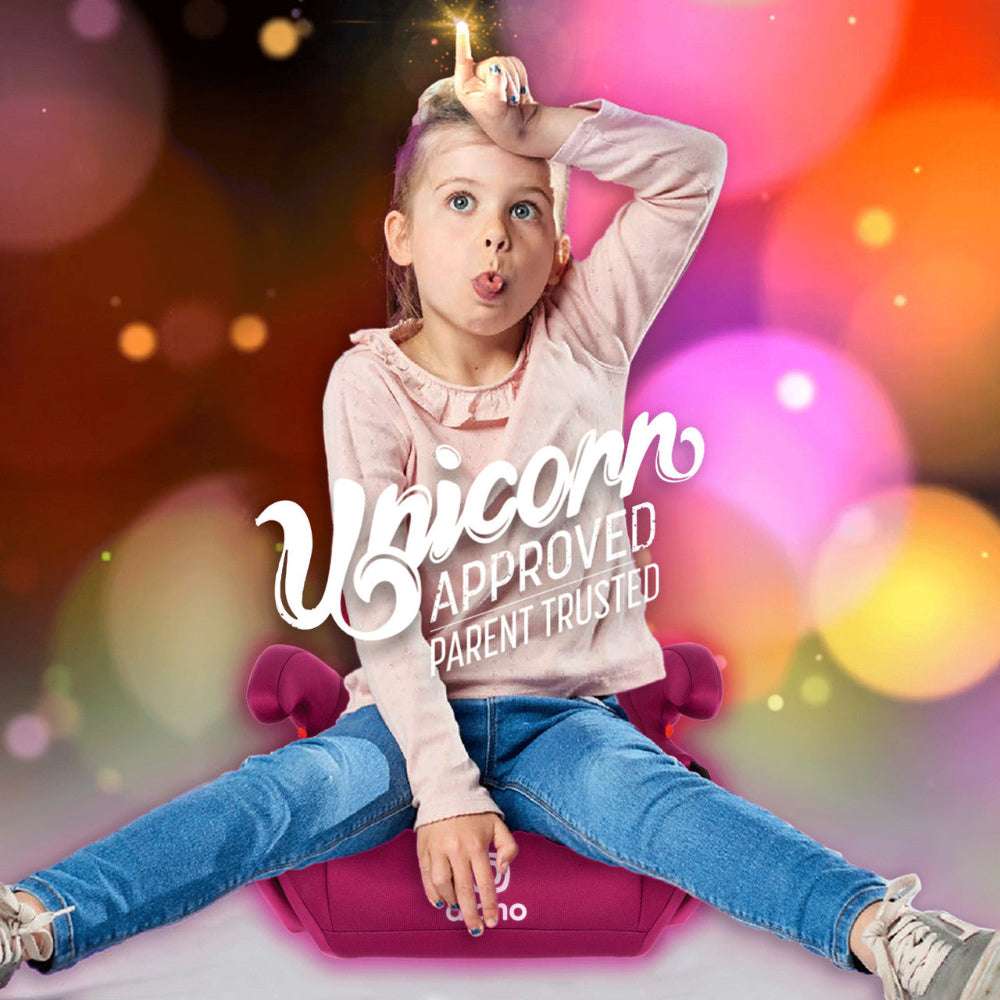 Diono Solana backless booster car seat in pink with a child sitting on it.