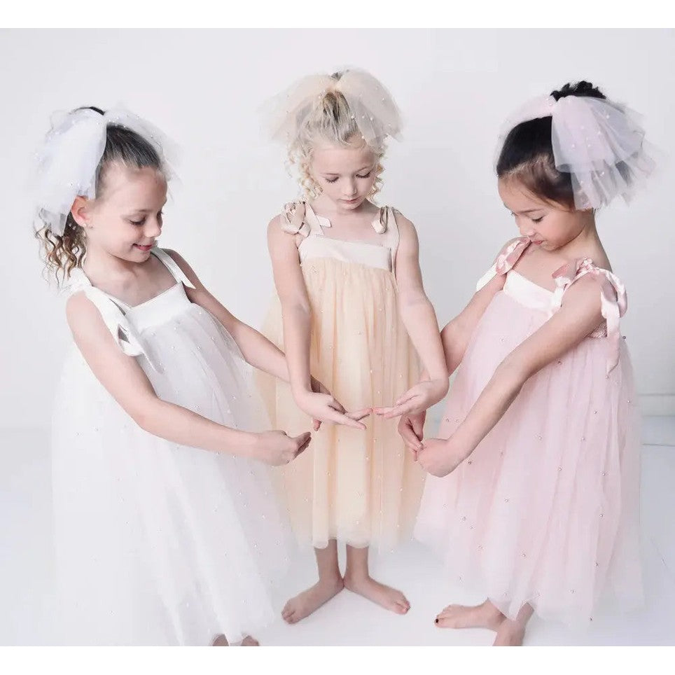 Dolly By Le Petit Pearl 2-Cute Tulle Dress trio in white, peach, pink as three girls hold hands in a circle.