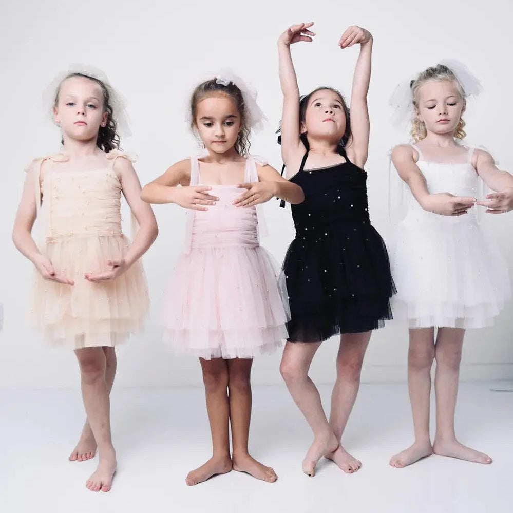 Dollypink Pearl Tulle Ballerina Dress by Dolly by Le Petit Tom; four girls in pink, peach, black tutus strike graceful dance poses.