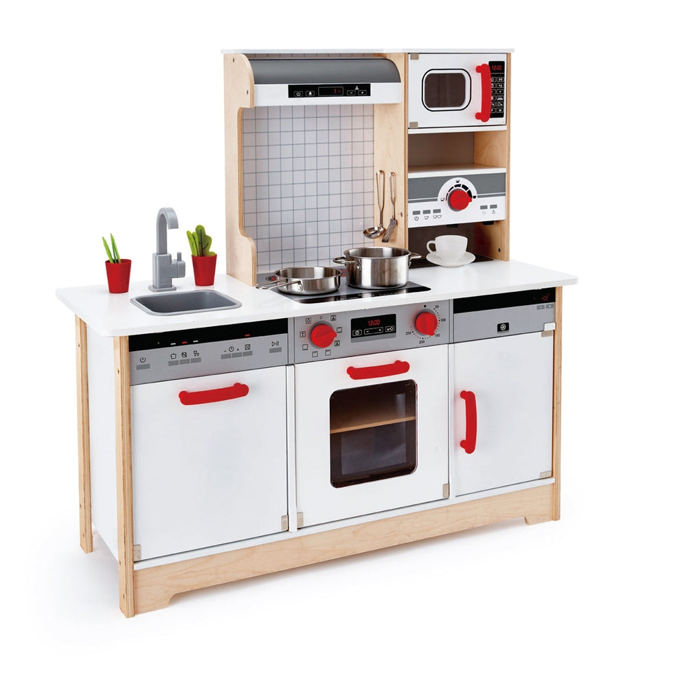 Hape All In 1 Kitchen playset, a wooden kids’ kitchen with white panels, red handles, stove, sink, oven, microwave.