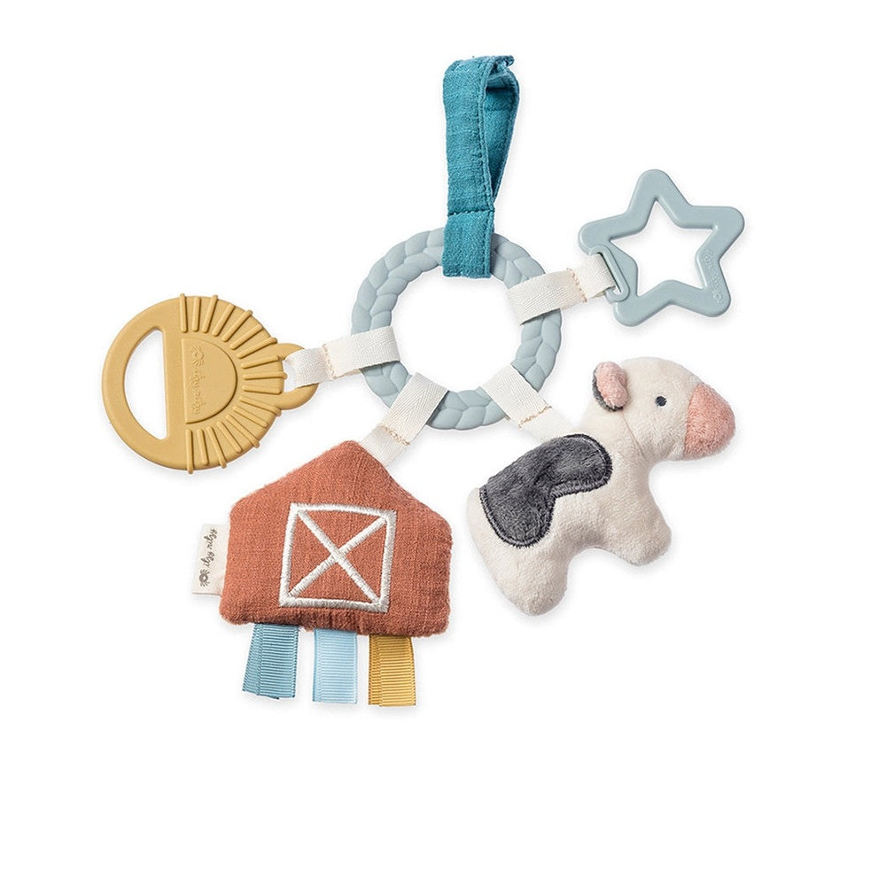 Itzy Ritzy Bitzy Busy Gift Set featuring plush cow, star teether, braided ring, and colorful ribbons