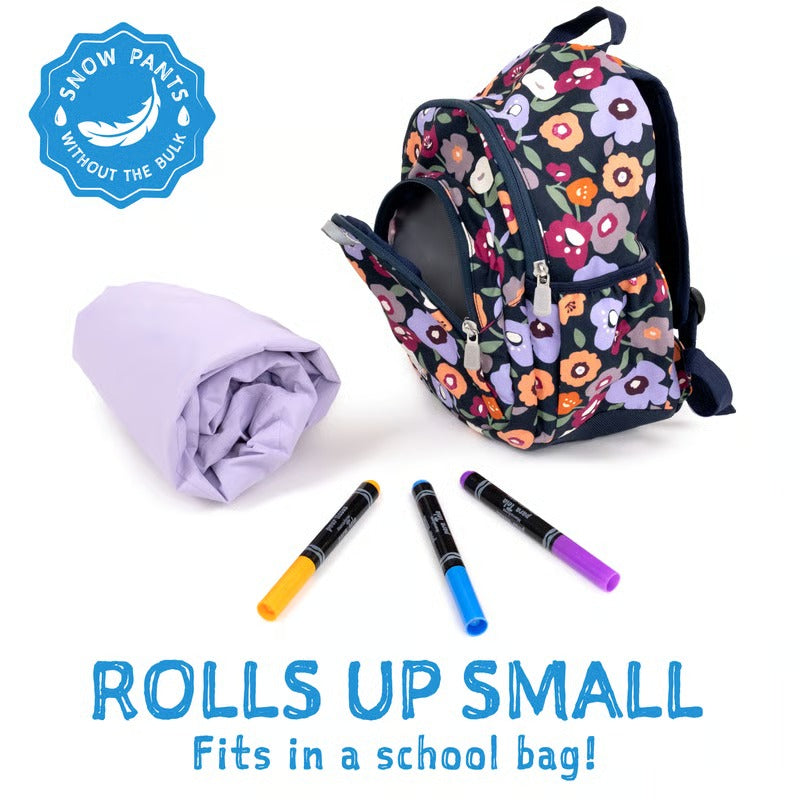 JAN & JUL waterproof cozy dry rain pants pink forest rolled up beside a floral backpack