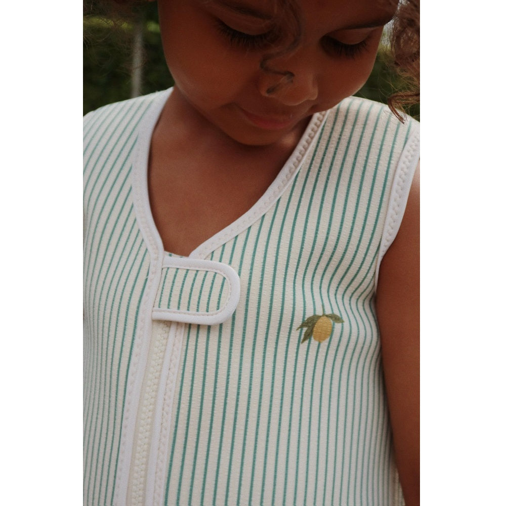 Konges Slojd Ellis Swim Vest Tea Stripe worn by a child, teal stripes, lemon emblem, white trim, with front loop closure