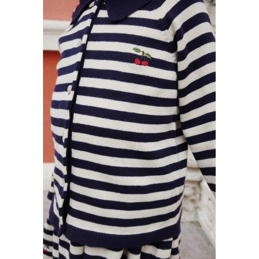 Konges Slojd Venton cotton knit cardigan in navy and white stripes, with cherry embroidery, worn by a toddler.