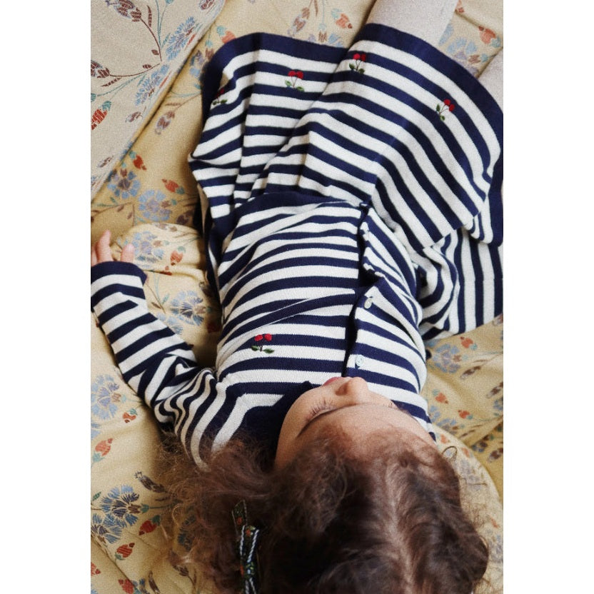 Konges Slojd Venton Cotton Knit Skirt Navy Stripe worn by baby, navy–white stripes with small cherry embroidery.