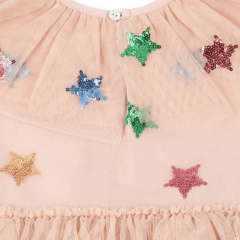 Konges Slojd Yvonne Fairy Dress Multi Star in peach tulle with colorful sequin stars sewn across the fabric.