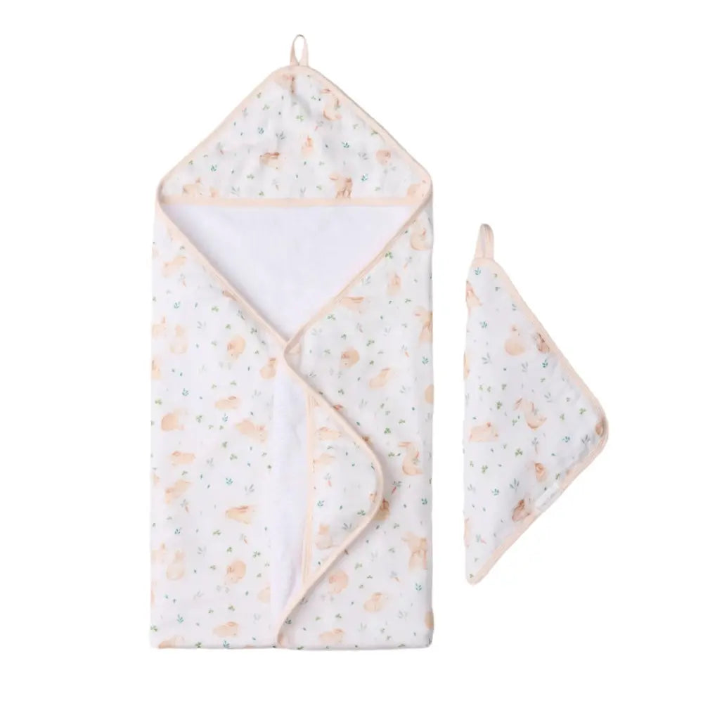 LOULOU LOLLIPOP Hooded Towel Set in peach animal print with matching washcloth, shown ready for bath.