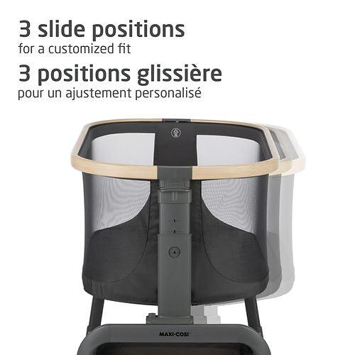 Maxi-Cosi Iora bedside bassinet with 3 slide positions, featuring gray mesh sides and beige rim.