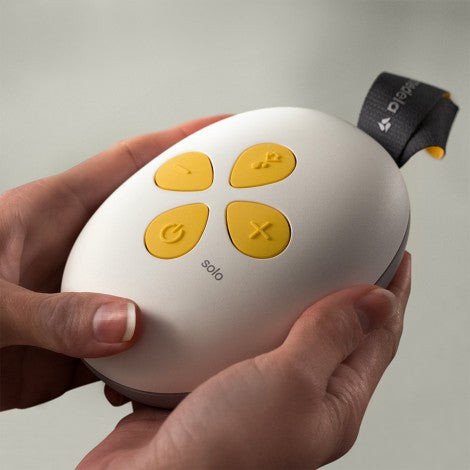 Medela Solo single electric breast pump, white with yellow control buttons, MEDELA brand.