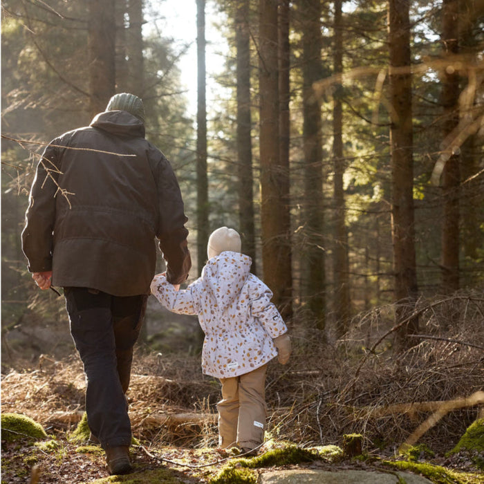 Mini A Ture Matwang fleece-lined toddler jacket on child walking hand-in-hand with adult in a forest