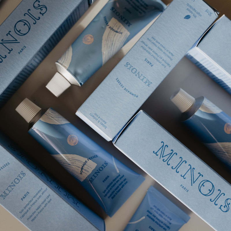 Minois Paris Diaper Cream 50 ml tube in blue packaging amid boxed sets