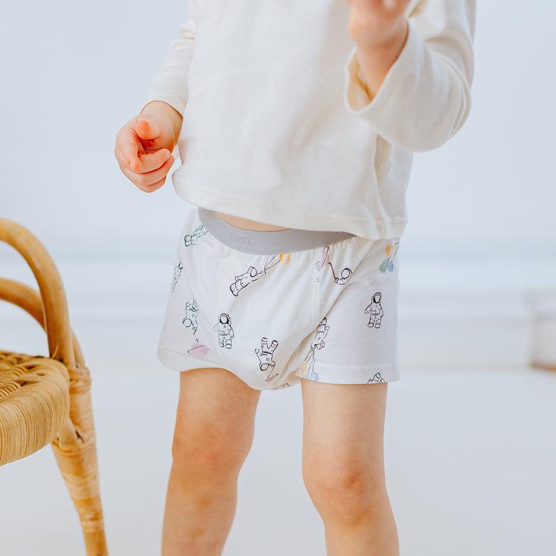 Nest Designs Bamboo Boys Boxer Briefs 2-Pack To Infinity; toddler wears white briefs with astronaut prints.