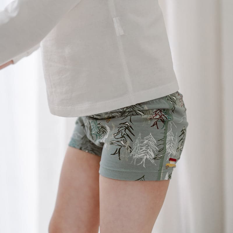 Nest Designs Bamboo Girls Boy Short Underwear Forest Fun 2-pack; sage green forest print worn by a child.