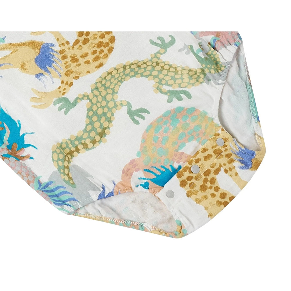 Nest Designs Bamboo Short Sleeve Onesie Dragon Dance; white with pastel dragon print, bottom snaps fastened.