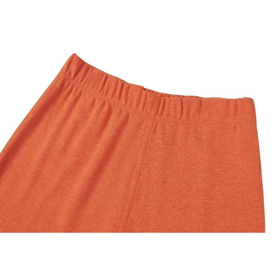 Nest Designs Tanboocel Pants Pantone Apricot Orange with elastic waistband, showing soft knit fabric texture.