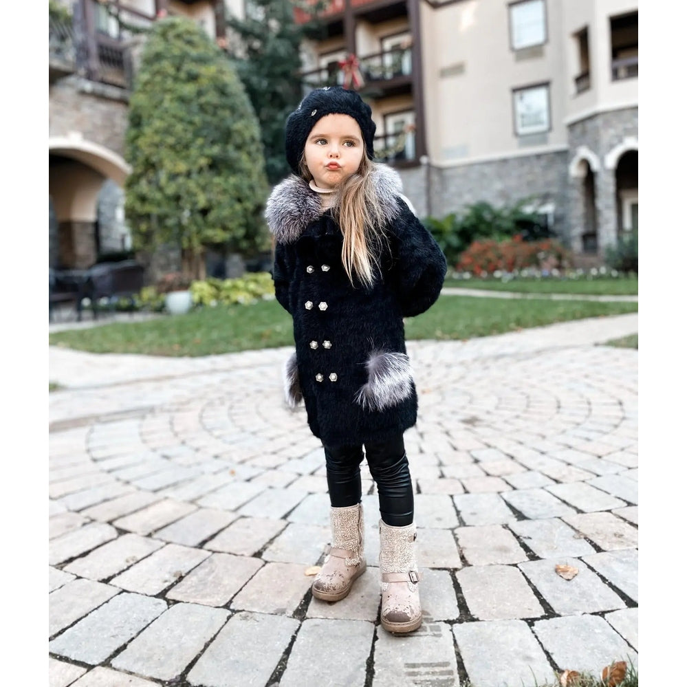 Petite Maison Kids Milana Noir Sweater Coat: girl in a black coat with grey fur trim and silver buttons outdoors.