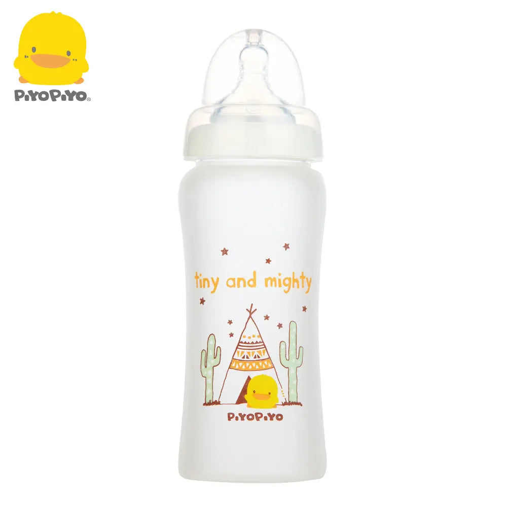 Piyo Piyo silicone wide-neck glass baby bottle in white, showing a clear nipple ready for feeding and playful chick design.