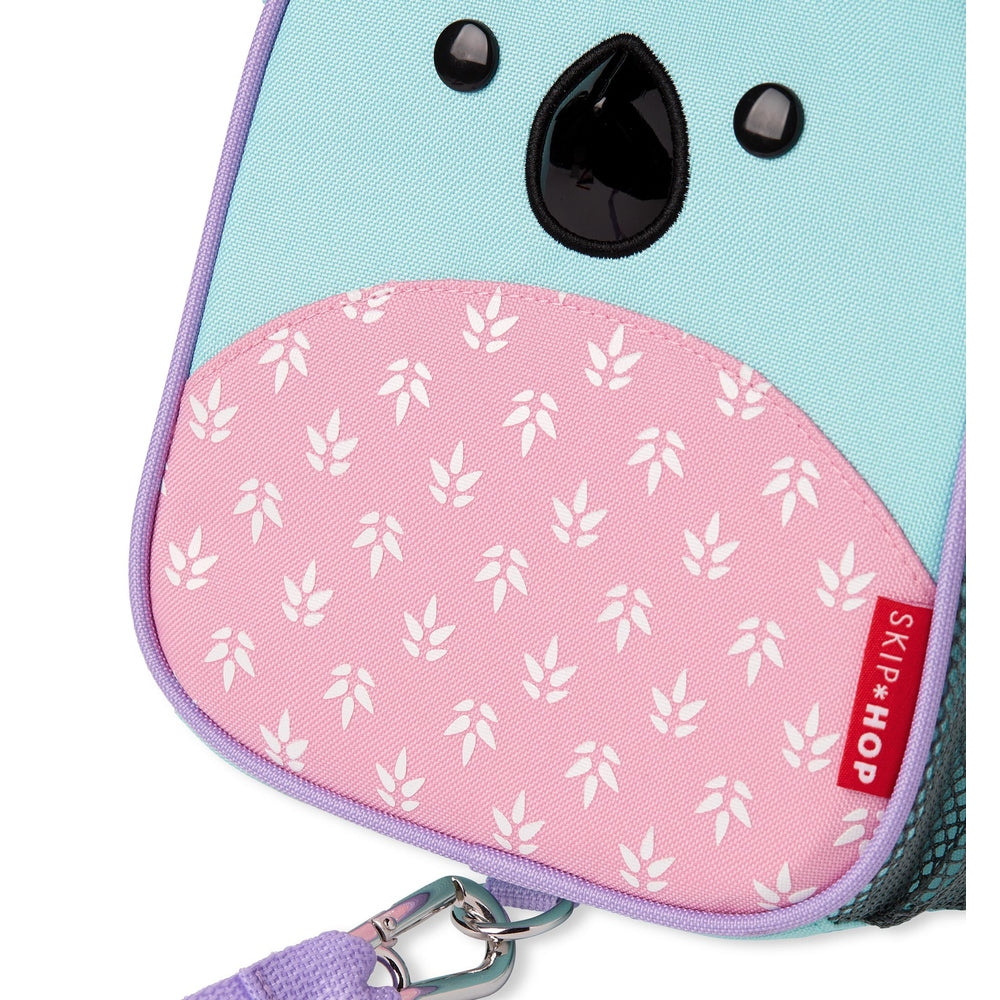 Skip Hop Koala mini backpack with safety harness; pastel turquoise body, pink leaf-pattern pocket, purple trim.