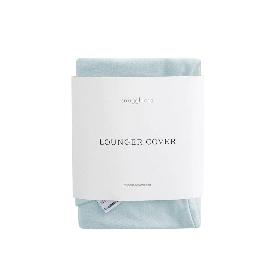 Snuggle Me Organic Infant Lounger Cover in soft blue fabric, neatly folded with brand label.