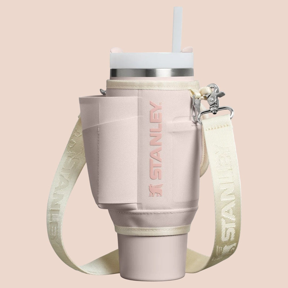 Stanley The All Day Quencher Carry-All 30 oz tumbler with pale pink body and cream strap