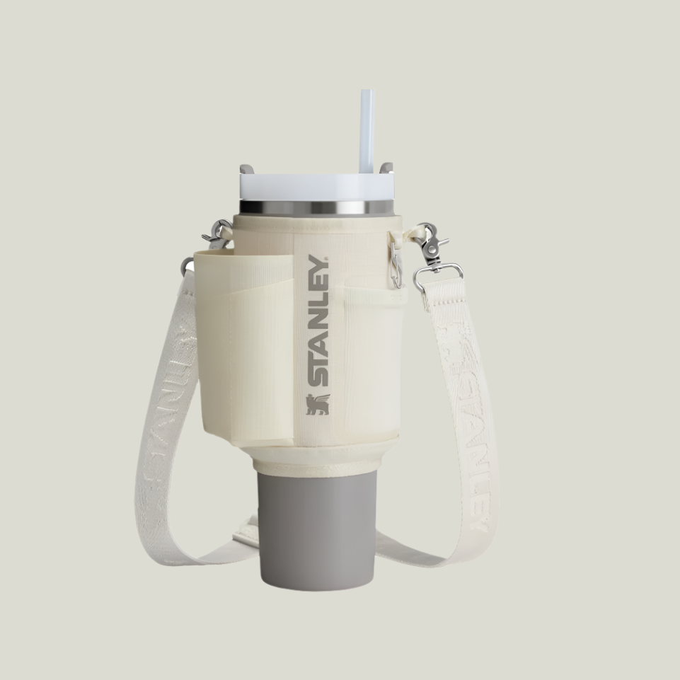Stanley All Day Quencher Carry-All 40 oz water bottle with cream body and white strap