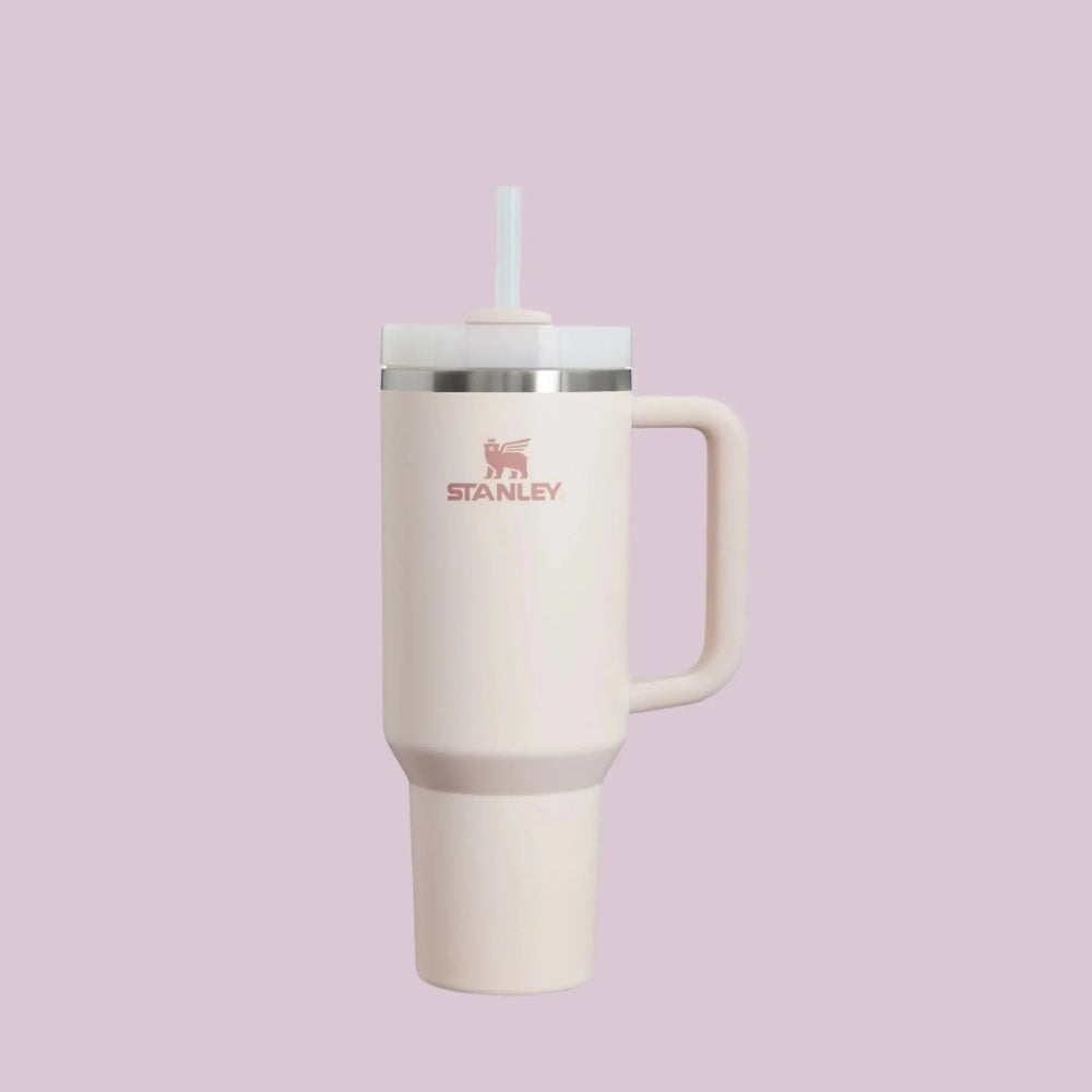 STANLEY The Quencher H2.0 Flowstate 40 oz tumbler in pale pink with straw lid and attached handle.