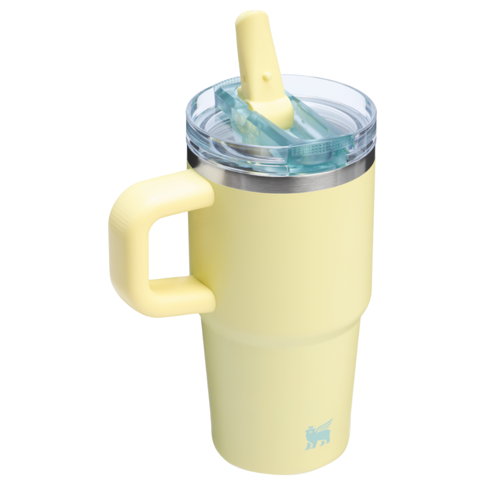 Stanley The Quencher Protour Flip Straw Tumbler 20 oz in pale yellow with clear lid, flip-straw raised for sipping.