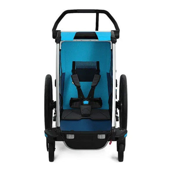 Thule Chariot Cross bicycle trailer with blue interior, black frame, and secured 5-point harness.