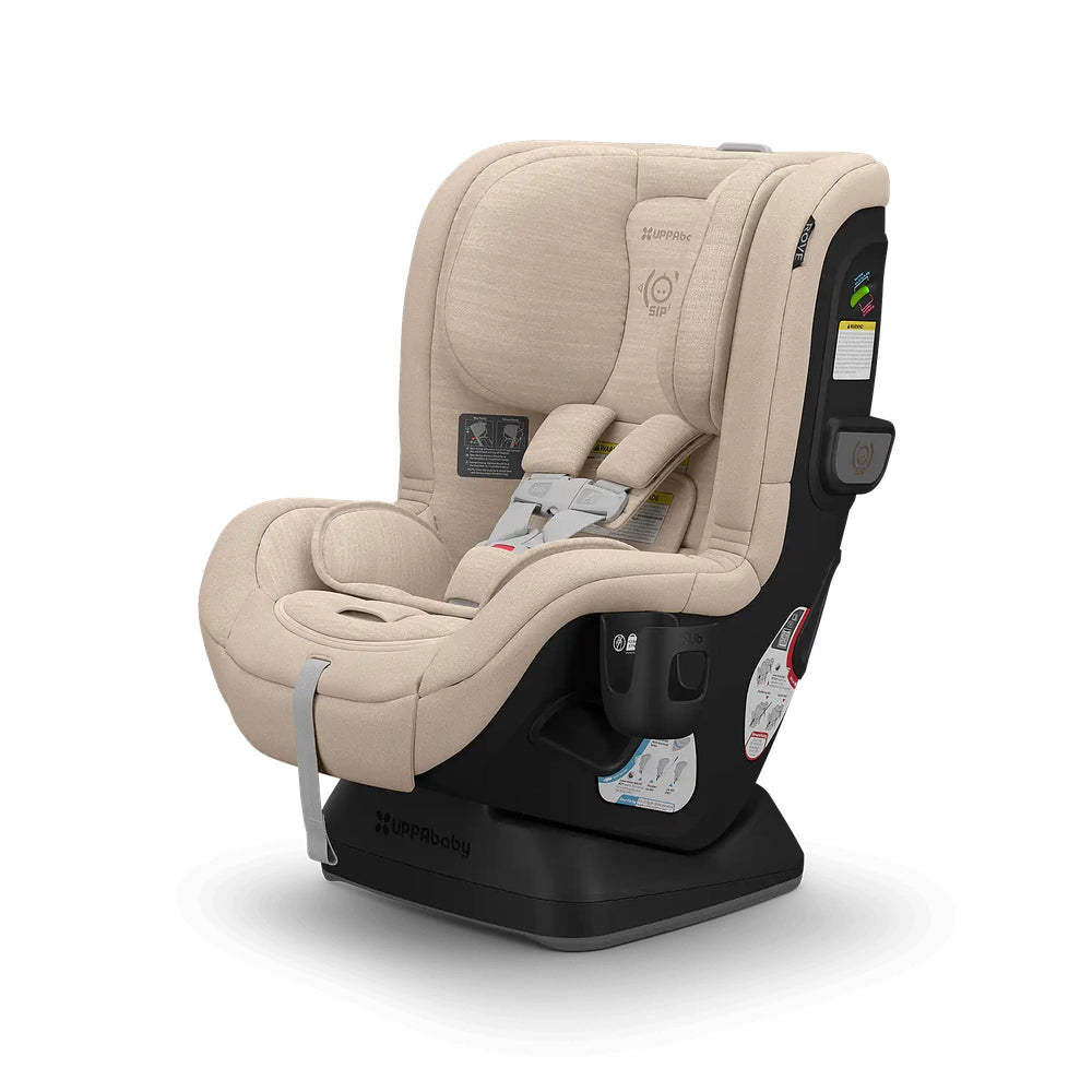Uppababy Rove convertible car seat in beige with a padded five-point harness and black base