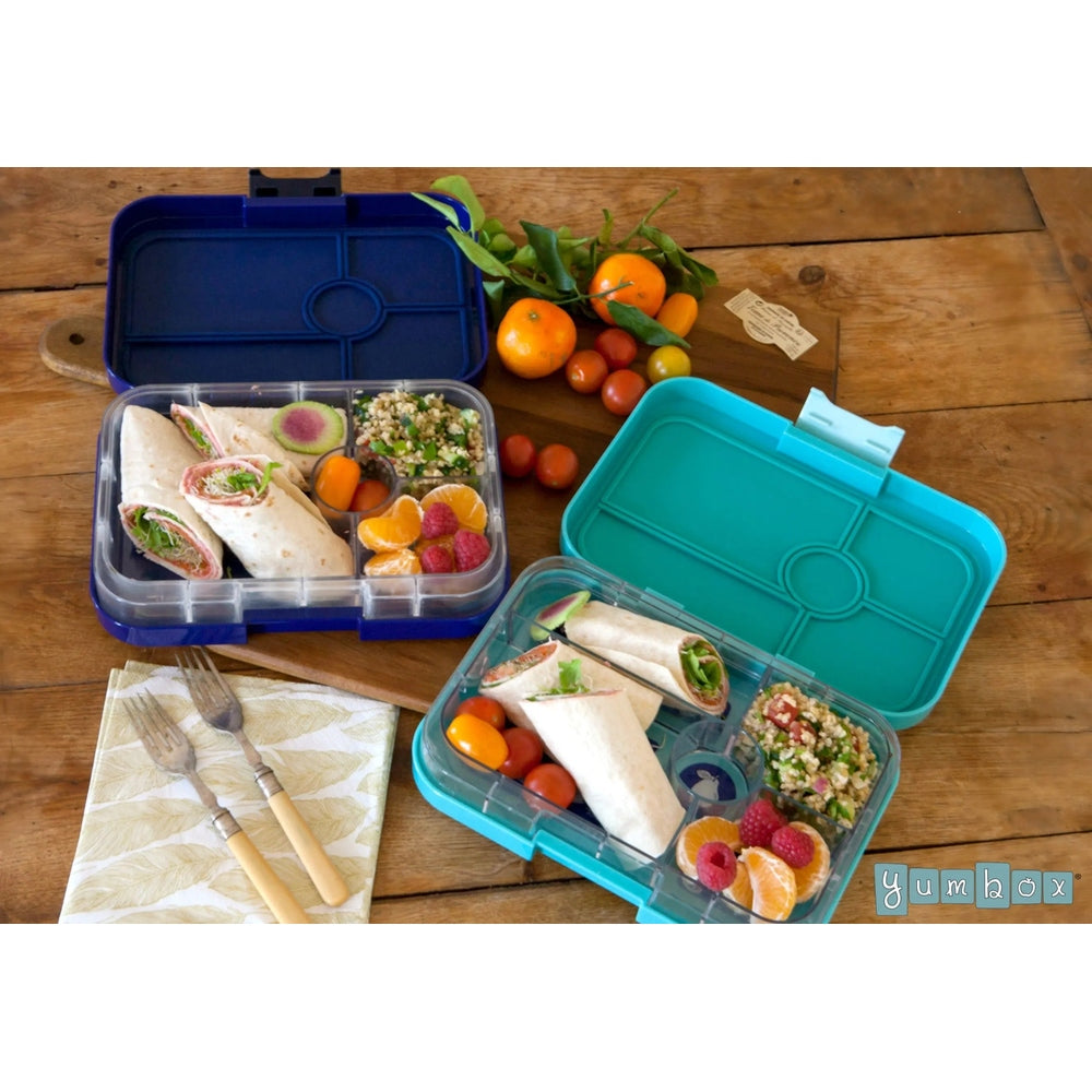 Yumbox Tapas 5 Compartment Lunchbox in blue and turquoise, open to reveal wraps, quinoa salad and citrus fruit.