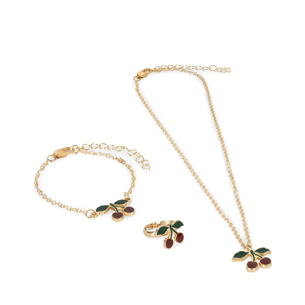 Konges Slojd Jewelry Set: gold-tone cherry pendant necklace with green leaves and red stones, plus matching bracelet and ring.