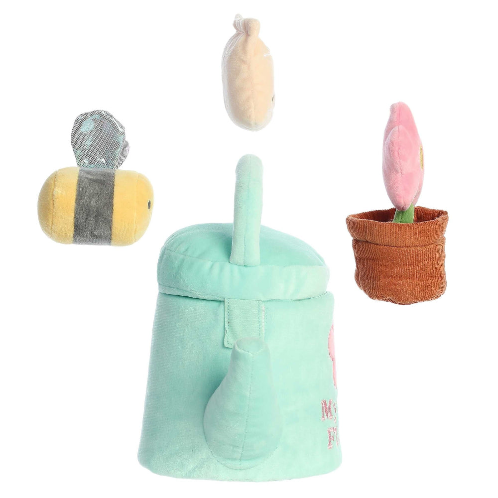 Set of soft toys including a bee, a flower, and a green container on a white background