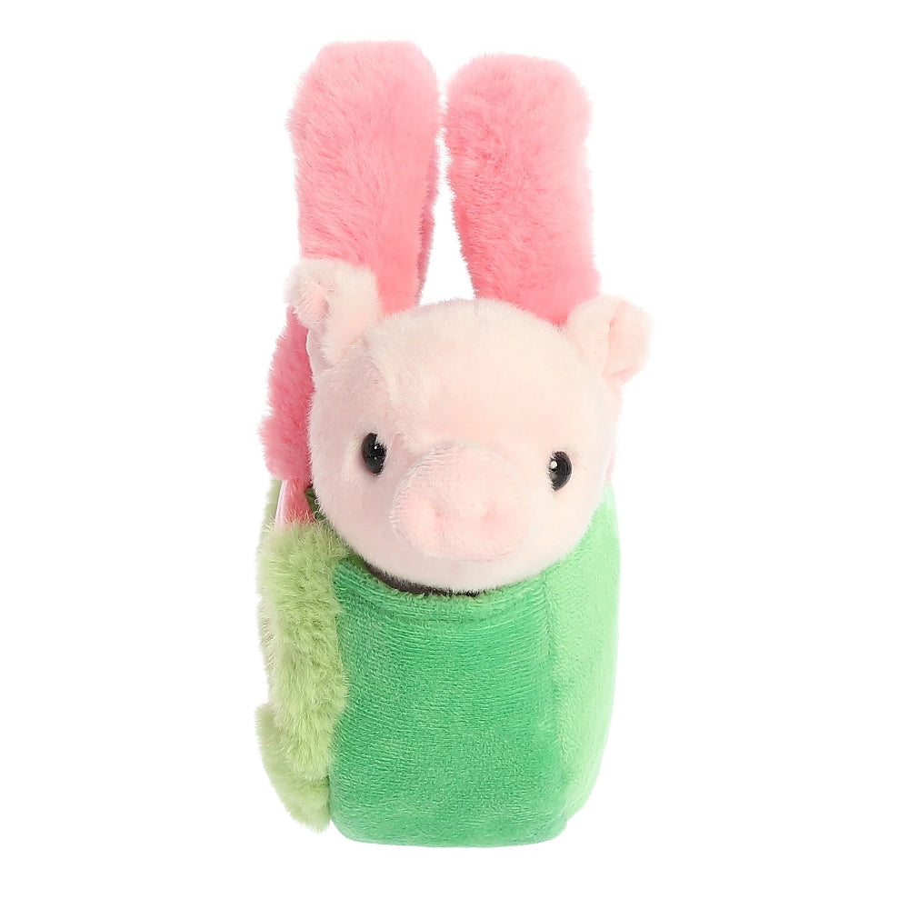 Plush toy of a pig with pink bunny ears and green outfit on a white background