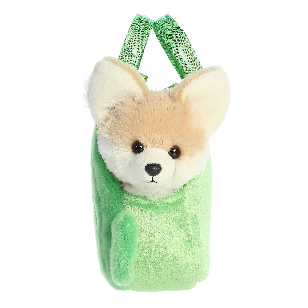 Plush dog toy with a green bag on a white background