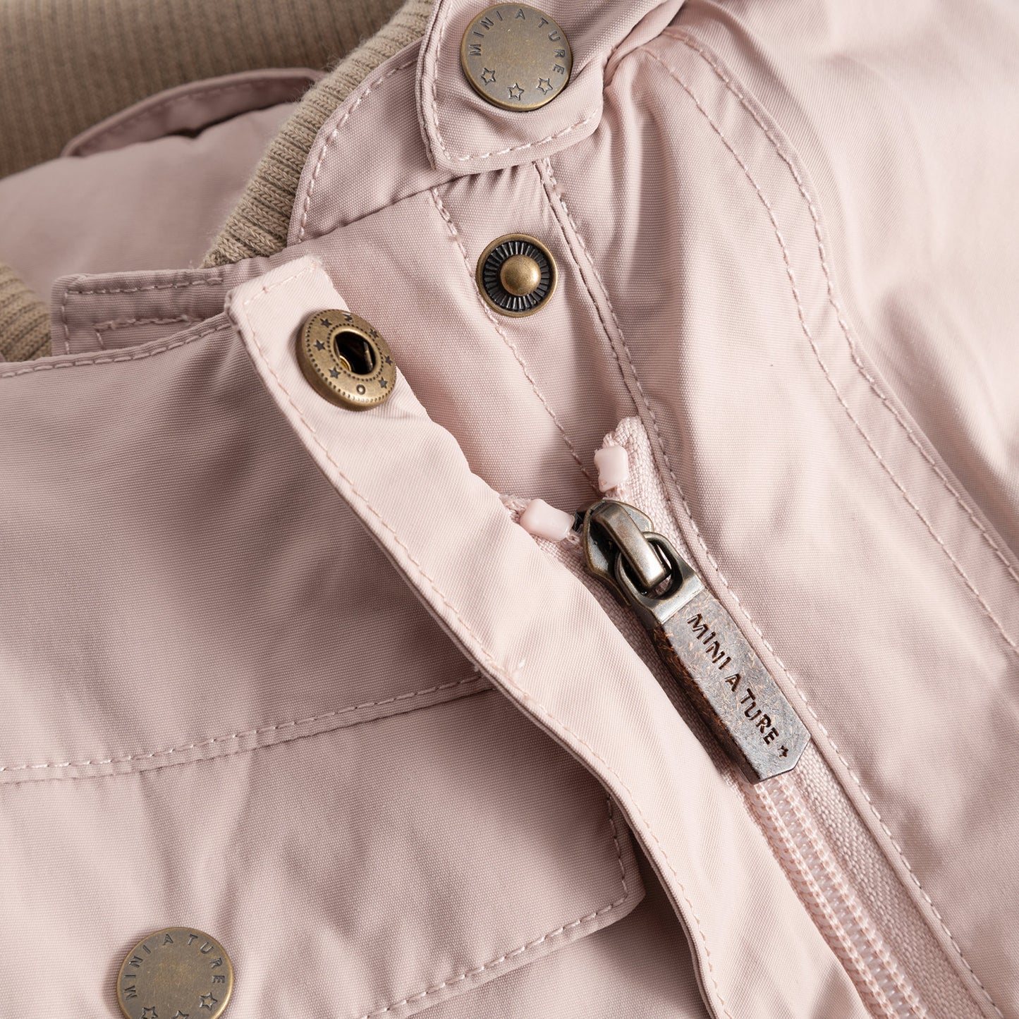 Mini A Ture Matwisti fleece-lined snowsuit in cloudy rose pink with brass snaps and zipper