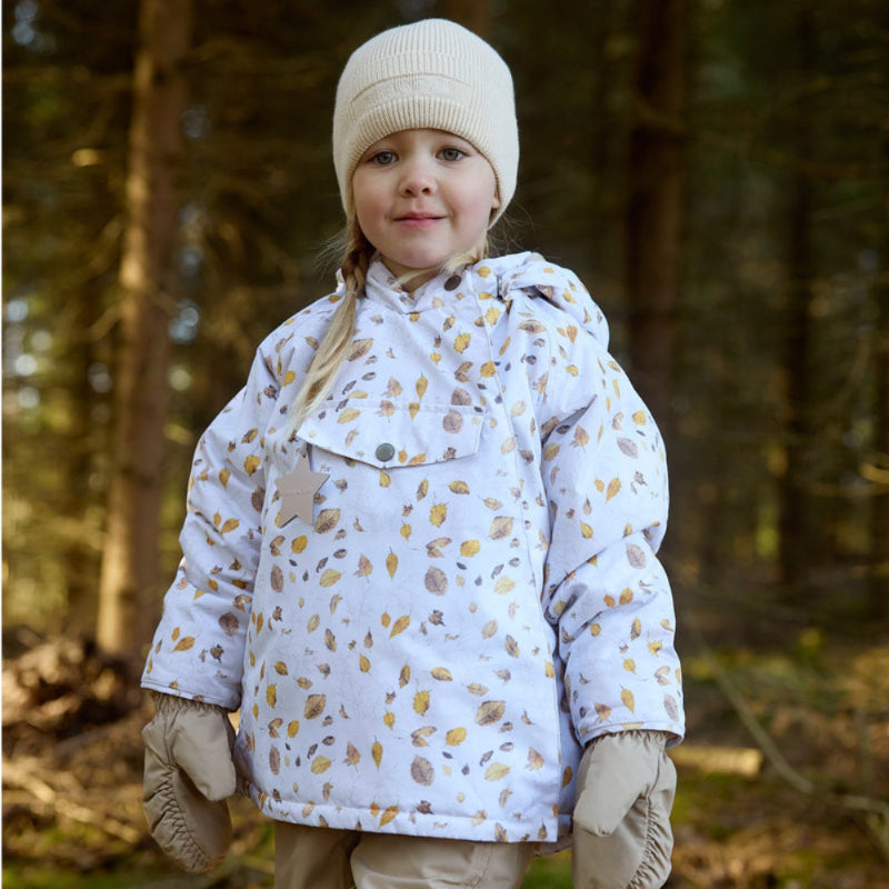 MINI A TURE Matwang fleece-lined toddler jacket with autumn leaf print worn by a little girl in a forest