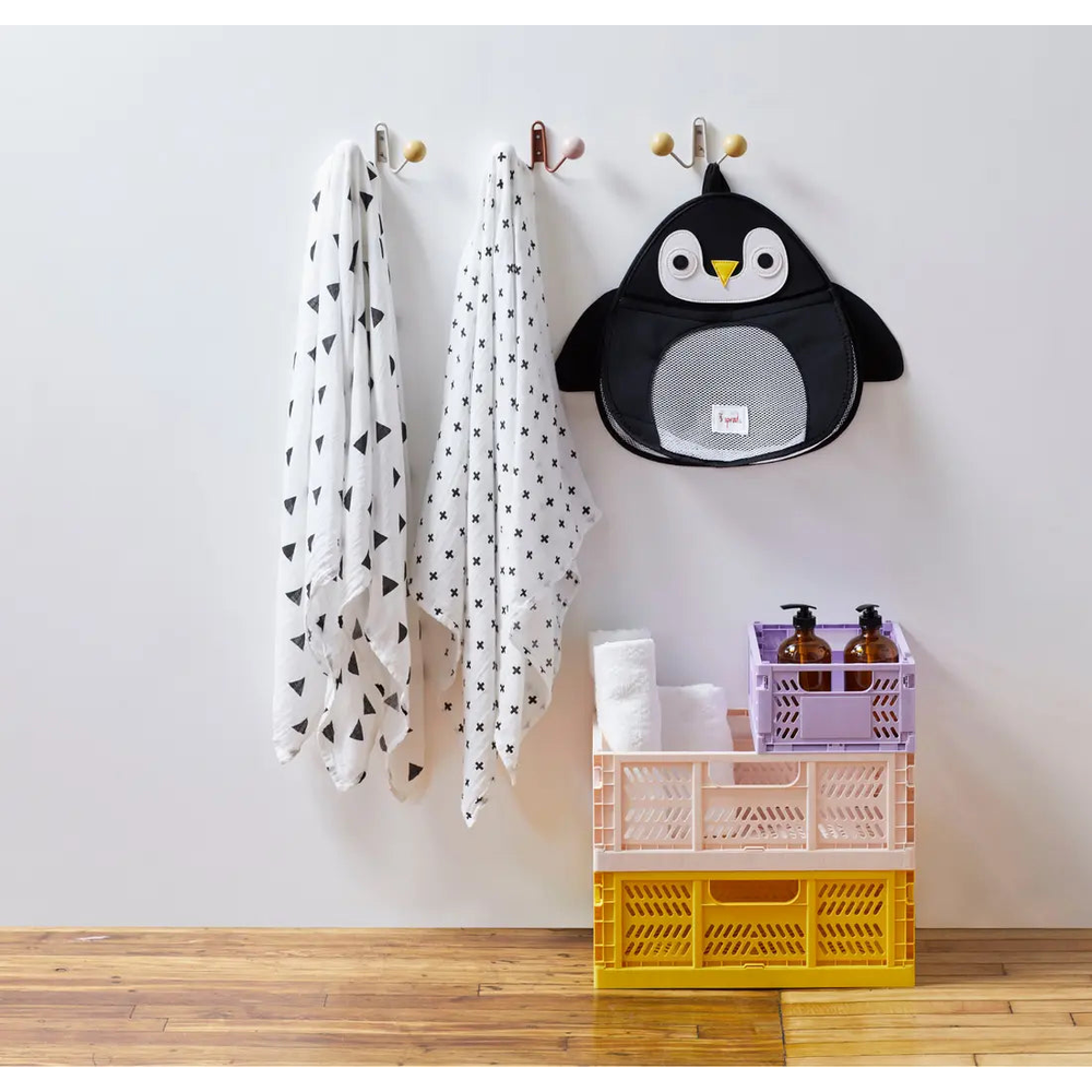 3 Sprouts Bath Storage organizer mounted on wall with towels, a penguin backpack, and pastel crates.