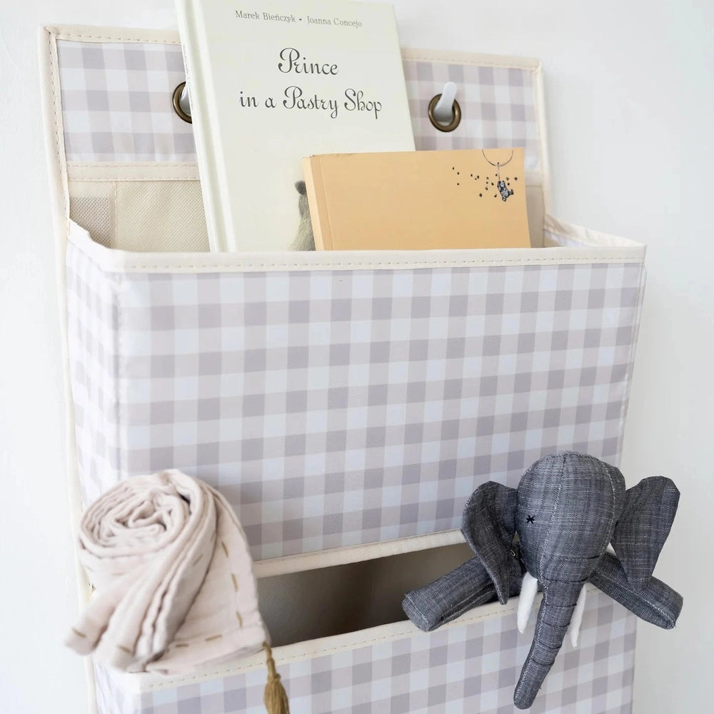 3 Sprouts beige gingham over-the-door fabric organizer with books and a gray elephant plush
