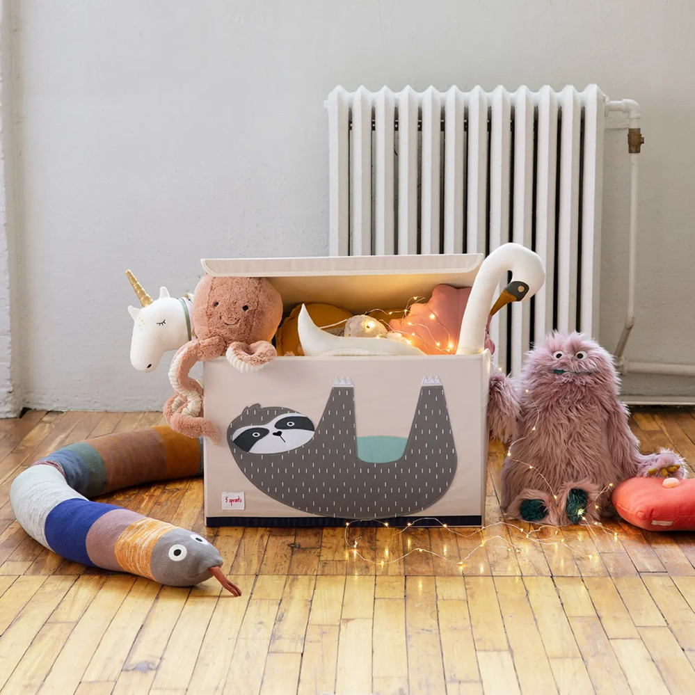 3 Sprouts Toy Chest, pink with sloth graphic, opens to reveal plush toys and glowing string lights inside.