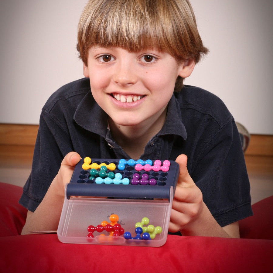 Smart Games IQ Fit puzzle game with colorful bone-shaped pieces and a blue lid