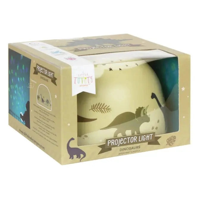 A Little Lovely Company Projector Night Light in beige packaging, showing dinosaur silhouettes as it projects light.